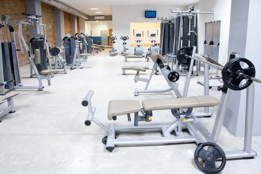 11982242 - fitness club gym with sport equipment modern interior